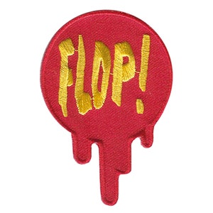 Könnte beinhalten: Roter und goldener gestickter Bügelaufkleber mit dem Wort "FLOP!" in einer tropfenden Schrift.