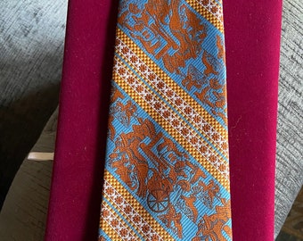 Awesome King Tut in a hunting scene  a  Vintage 1970s Orange and Blue Super Wide Tie from Oleg Cassini with
