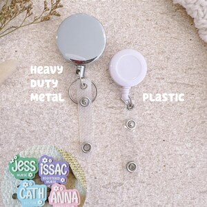 May include: Two badge reels are displayed: a circular heavy duty metal reel with a clear strap and a smaller circular white plastic reel with a clear strap. A circular inset shows four colorful badge reels labeled Jess Nurse, Issac Registered Nurse, Cath Doctor, and Anna Enrolled Nurse.