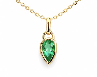 May include: A gold necklace featuring a pear-shaped green gemstone pendant set in a smooth gold bezel. The pendant hangs from a delicate gold chain with small, uniform oval links. The gemstone displays a vibrant, translucent green hue.