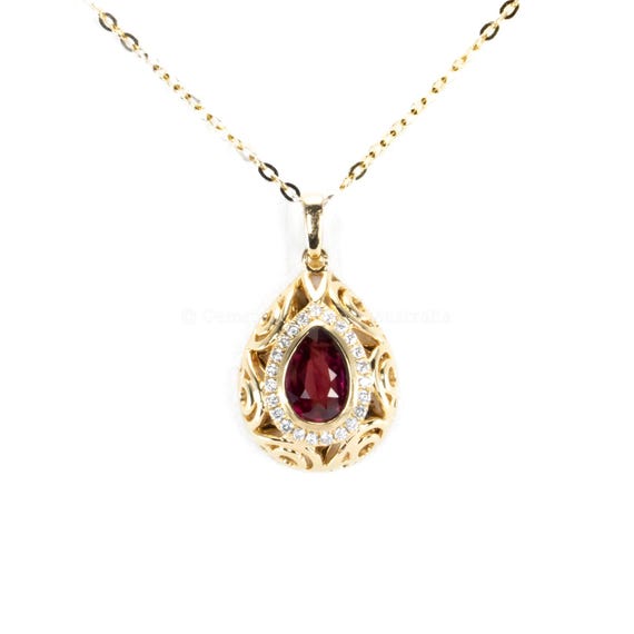 Pear Shape Unheated Ruby Pendant with Diamond Halo in Elegant Drop Design