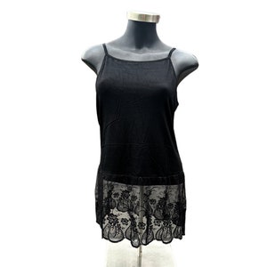 May include: Black sleeveless slip dress with a lace trim at the hem.