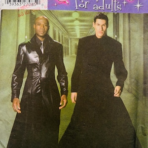 May include: Simplicity 5386 sewing pattern for adult costumes featuring two long, floor-length coats. One coat is a black leather-look trench style with a collar and buttons, while the other is a solid black, high-neck, long-sleeved coat.