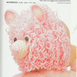 May include: A pink crocheted bear hat with white eyes. The hat is shown on a child wearing a pink shirt.