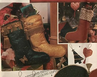 May include: Simplicity Holiday pattern collection featuring various Christmas stocking designs. Includes a green stocking with a butterfly, a gold stocking, and other ornaments. The pattern is one size.