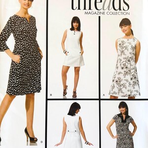 May include: Simplicity sewing pattern featuring several dress designs. The dresses include a polka dot print, floral embroidery, and solid white options. The pattern includes the text "threads MAGAZINE COLLECTION".