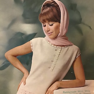 May include: A vintage advertisement for Mary Maxim knitting patterns featuring a woman wearing a white crocheted top with a pink scarf. The text "Lines of Elegance" is featured at the bottom of the image.