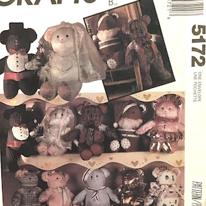 May include: A sewing pattern for making 10 different teddy bears. The pattern includes instructions for making a bride and groom bear, a Santa bear, a bear with a plaid vest, a bear with a pink dress, a bear with a blue and white striped shirt, a bear with a gold dress, and a bear with a floral dress. The pattern is called "Des Amours D'Ours" and "Learn to Sew for Fun".