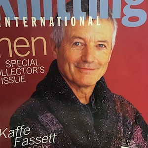 May include: A magazine cover featuring a man wearing a purple and black knitted sweater. The magazine is titled "Knitting International" and features the text "Special Collector's Issue" and "Kaffe Fassett In Living Color".