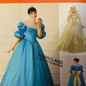 May include: Simplicity sewing pattern number 728 D5 for a princess costume. The pattern includes instructions for making a blue gown with puffed sleeves and a yellow sash, as well as a white gown with a lace trim.