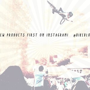 May include: A person on a bicycle performs a trick in the air, with a blurred background of a crowd and buildings. The text "SEE NEW PRODUCTS FIRST ON INSTAGRAMI @BIKEBLOTTER" is visible at the top of the image.