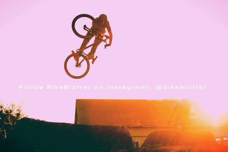 May include: A person performs a bike trick in the air, silhouetted against a pink and orange sunset. The bike is black and has a black seat. The person is wearing a black helmet and black clothing. The text "Follow BikeBlotter on Instagram! @bikeblotter" is visible at the bottom of the image.