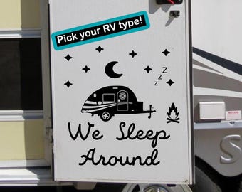 May include: A black vinyl decal applied to a white RV door featuring a teardrop camper, a crescent moon, stars, a campfire, and the text "Pick your RV type!" at the top and "We Sleep Around" in a cursive font at the bottom.