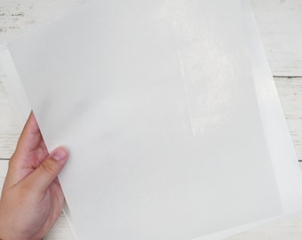 May include: A white sheet of parchment paper, often used for baking or crafting.