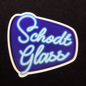 May include: A blue and white sticker with the text "Schodt Glass" in a neon-style font.