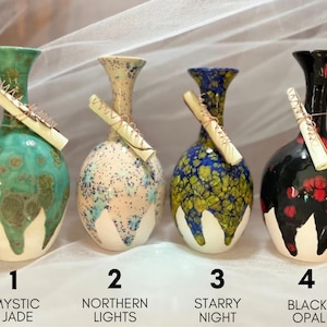 May include: Four ceramic vases with unique designs and colors. The vases are labeled 1. Mystic Jade, 2. Northern Lights, 3. Starry Night, and 4. Black Opal.