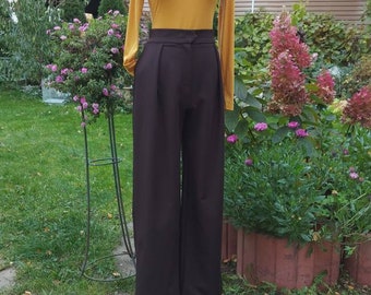 May include: A brown wide-leg pant with a high waist and a mustard yellow turtleneck top.