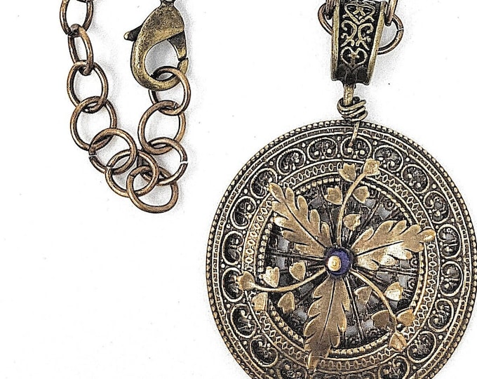 Beautiful Brass Oval Link Chain accented with a unique Filigree Pendant.