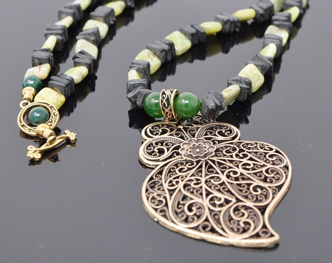 Single strand hand beaded necklace with Peridot and wood chips.