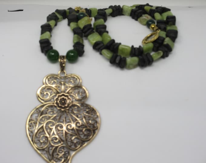 Single strand hand beaded necklace with Peridot and wood chips. Imported Portuguese pendant