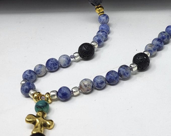 Single strand necklace with cross.