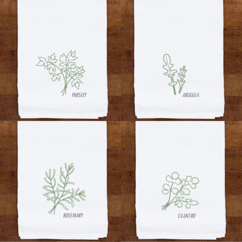 May include: Four white kitchen towels with green botanical illustrations. Each towel features a different herb: parsley, arugula, rosemary, and cilantro. The herb names are printed below each illustration.