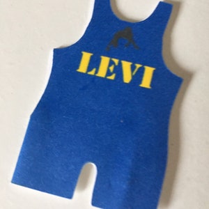 May include: Blue wrestling singlet with a black silhouette of a wrestler and the name "LEVI" in yellow letters.
