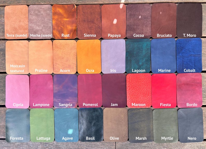 May include: A grid of thirty-two rectangular leather swatches in various colors and textures. Each swatch is labeled with its color name, including Terra, Mocha, Rust, Sienna, Papaya, Cocoa, Bruciato, T. Moro, Moccasin, Praline, Acorn, Ocra, Iris, Lagoon, Marine, Cobalt, Cipria, Lampone, Sangria, Pomerol, Jam, Maroon, Fiesta, Bordo, Foresta, Lattuga, Agave, Basil, Olive, Marsh, Myrtle, and Nero.