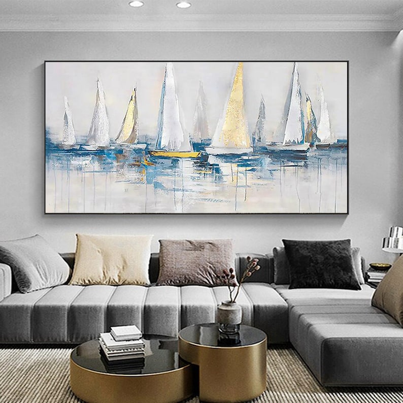May include: Abstract painting of sailboats in shades of white, blue, and gold on a light gray background. The sailboats are arranged in a row, with the water in the foreground and the sky in the background.