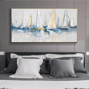 May include: Abstract painting of sailboats on a blue and white water background. The sailboats are white with gold accents. The painting is framed in a gold frame.
