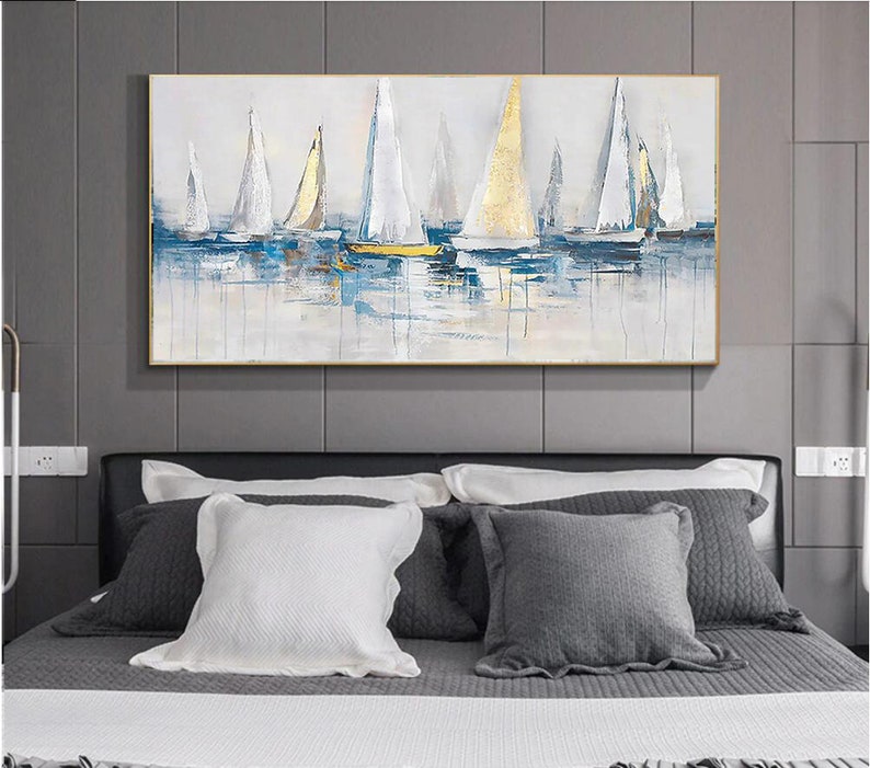 May include: Abstract painting of sailboats on a blue and white water background. The sailboats are white with gold accents. The painting is framed in a gold frame.