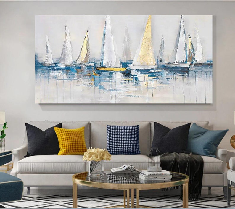 May include: Abstract painting of sailboats on a blue and white sea. The sailboats are white with gold accents. The painting is on a canvas and has a textured finish.