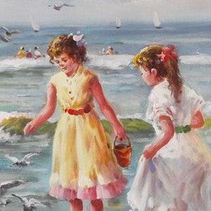 May include: Two girls in white and yellow dresses play on a beach with blue water and white waves. One girl holds a red bucket. Seagulls fly overhead.