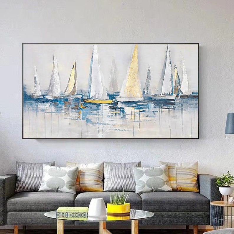 May include: Abstract painting of sailboats in shades of blue, white, and gold on a white background. The sailboats are arranged in a row, with the largest sailboat in the center. The painting has a textured, brushstroke effect.