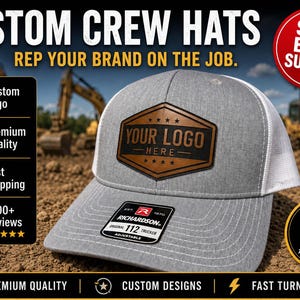May include: A grey and white trucker hat featuring a brown leather-look patch with the text YOUR LOGO HERE. The hat has a Richardson 112 sticker on the brim. Text on the image includes CUSTOM CREW HATS, REP YOUR BRAND ON THE JOB, SALE ENDS SUNDAY, and YOUTH SIZES Available.