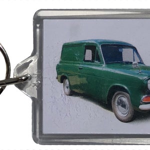 May include: A green Ford Transit van keychain with a clear plastic frame and a metal ring.