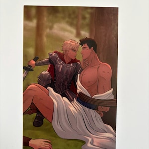 May include: An illustration depicts two figures in a forest setting. One figure, clad in armor and a red cape, holds a sword. The other, shirtless and draped in white fabric, is seated. The artwork has a fantasy theme.