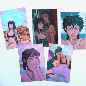 May include: A collection of five art prints featuring illustrations of women in various poses. The prints showcase a range of styles, including portraits and scenes with a tiger. The color palette includes blues, pinks, and purples.