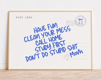 May include: A framed postcard with the words "HAVE FUN CLEAN YOUR MESS CALL HOME STUDY FIRST DON'T DO STUPID SHIT Mom" written in blue. The postcard has a postage stamp design in the upper right corner and the words "POST CARD" at the top.