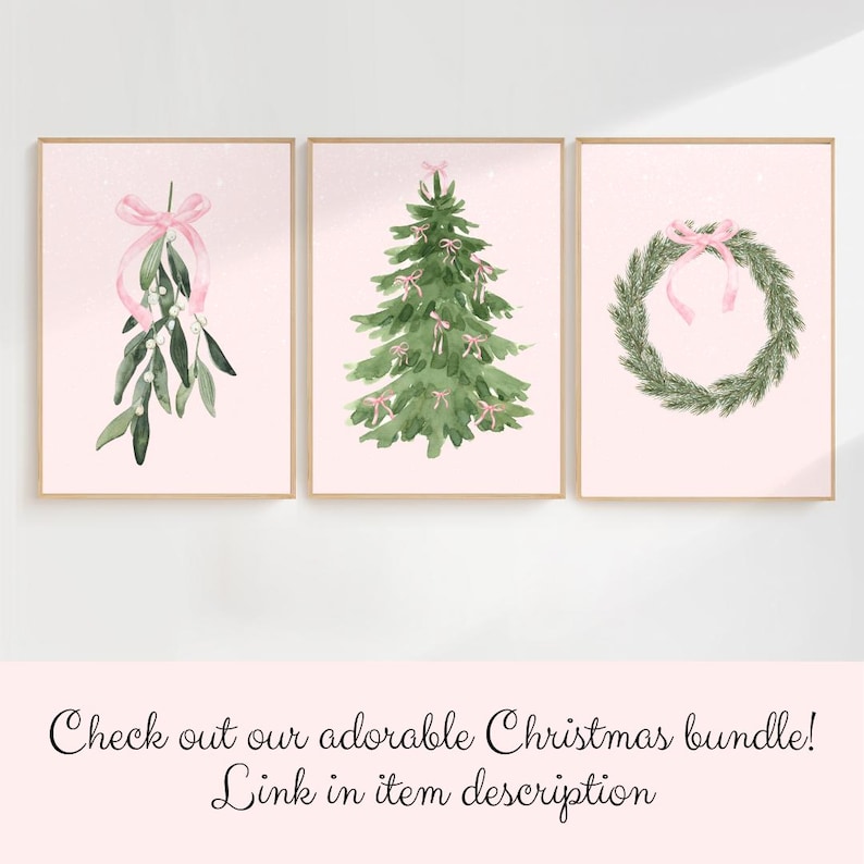 May include: Three framed watercolor prints with a Christmas theme. The prints feature a sprig of mistletoe with a pink bow, a Christmas tree adorned with pink bows, and a wreath with a pink bow. The background is a soft pink color.
