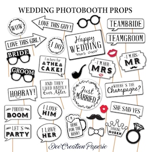 May include: A set of 20 black and white wedding photo booth props. The props include phrases like "I Do", "Just Married", "Team Bride", "Team Groom", "Where's the Champagne?", and "She Said Yes".