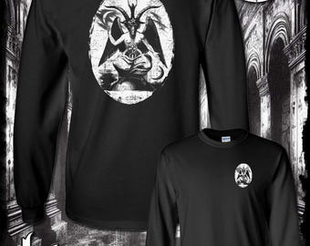 May include: Black long-sleeve shirt with a white graphic of a demon with wings and horns. The shirt has the text "Kinsman Trading Co. LLC" printed on the bottom.