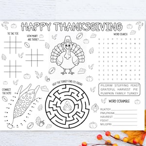 May include: A black and white Thanksgiving activity placemat with the words "Happy Thanksgiving" at the top. Includes tic-tac-toe, a word search, a maze, connect-the-dots, and a word scramble. Features a turkey illustration.
