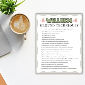 May include: A rectangular white paper sheet titled WELLNESS GROUND TECHNIQUES in green and black text, featuring a list of twenty numbered grounding prompts. The document includes small pink brain illustrations and has a wavy light gray border.