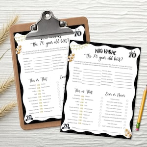 May include: A wooden clipboard holds two black and white party game sheets with the text "Who Knows the 70 year old best?" and "This or That". A pencil rests on the surface.
