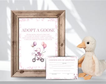 May include: A framed print with the text "ADOPT A GOOSE" and a watercolor illustration of a goose on a tricycle holding balloons. A plush goose toy and a certificate of adoption are also present.