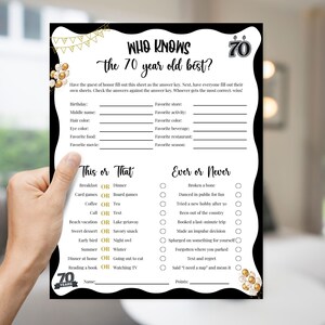 May include: A black and white game sheet titled "Who Knows the 70 Year Old Best?" with fill-in-the-blank questions and "This or That" and "Ever or Never" sections. The sheet is held by a hand.