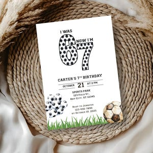 May include: A white invitation card with the text "I WAS 6 NOW I'M 7" in black. The card is for Carter's 7th birthday, with the date October 21st at 2 PM. Soccer balls and green grass are at the bottom.