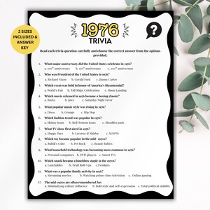 May include: A trivia game sheet about 1976, featuring questions on various topics like movies and music. The sheet is black and white, with the title "1976 Trivia" at the top. The sheet is on a white background with eucalyptus leaves.