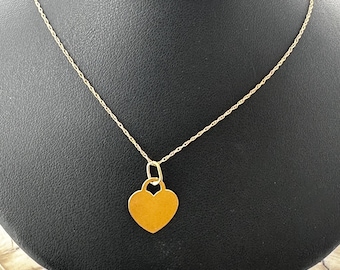Thin, 14 karat yellow gold heart pendant with chain.